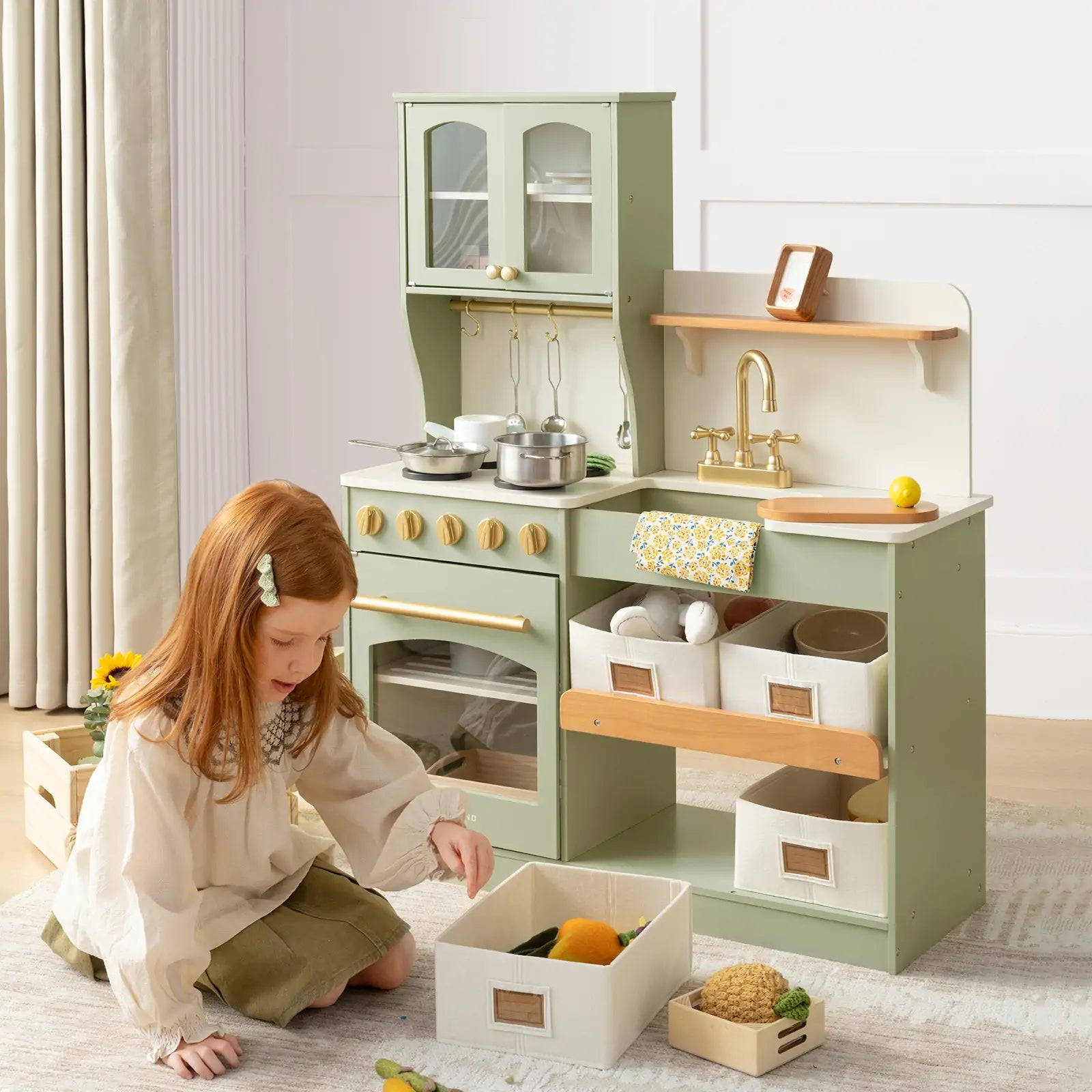 Child playing with a green wooden play kitchen set 